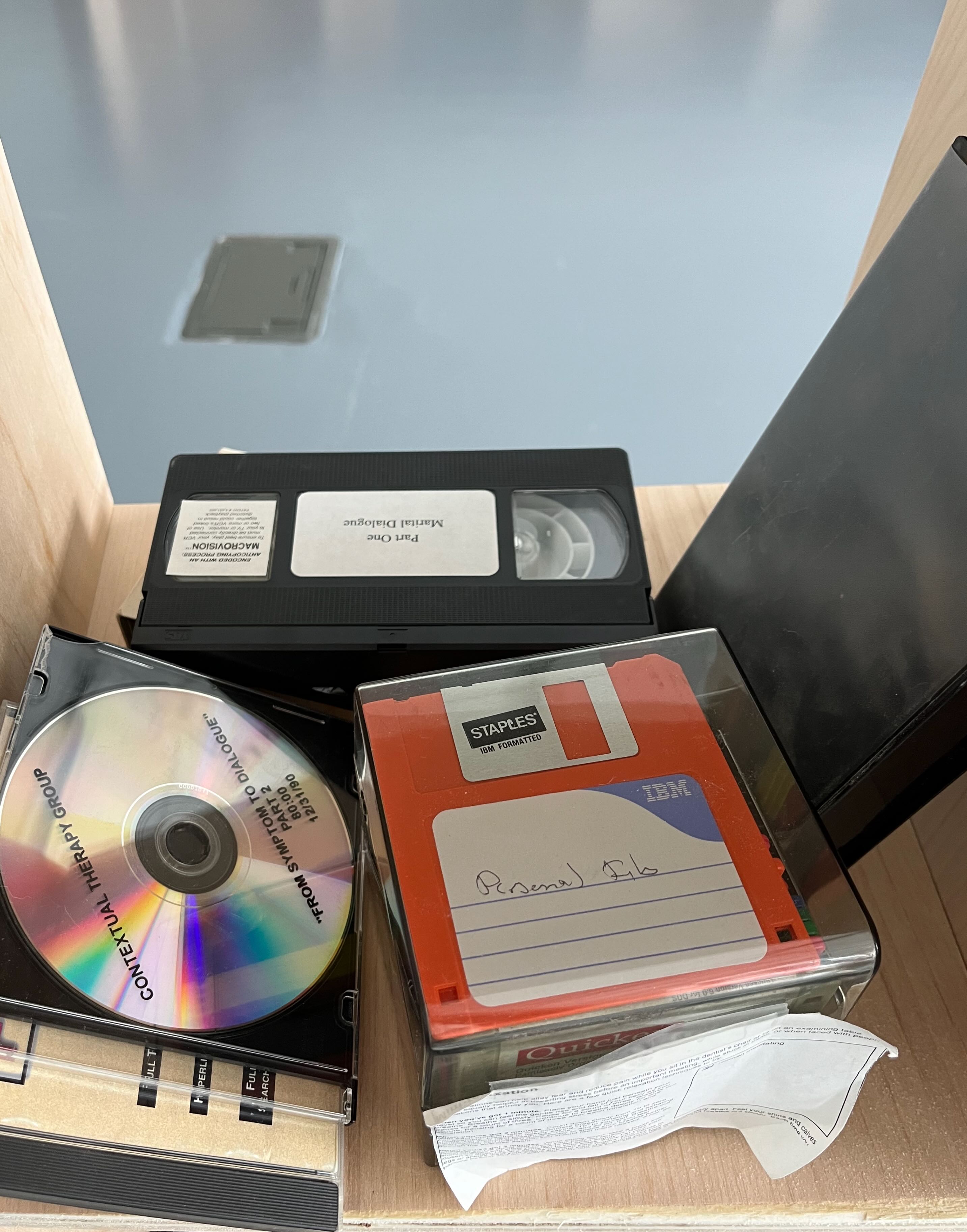 Image of CDs, VHS tapes, and a clear plastic box of floppy discs with the top disc labeled 'Personal Files'