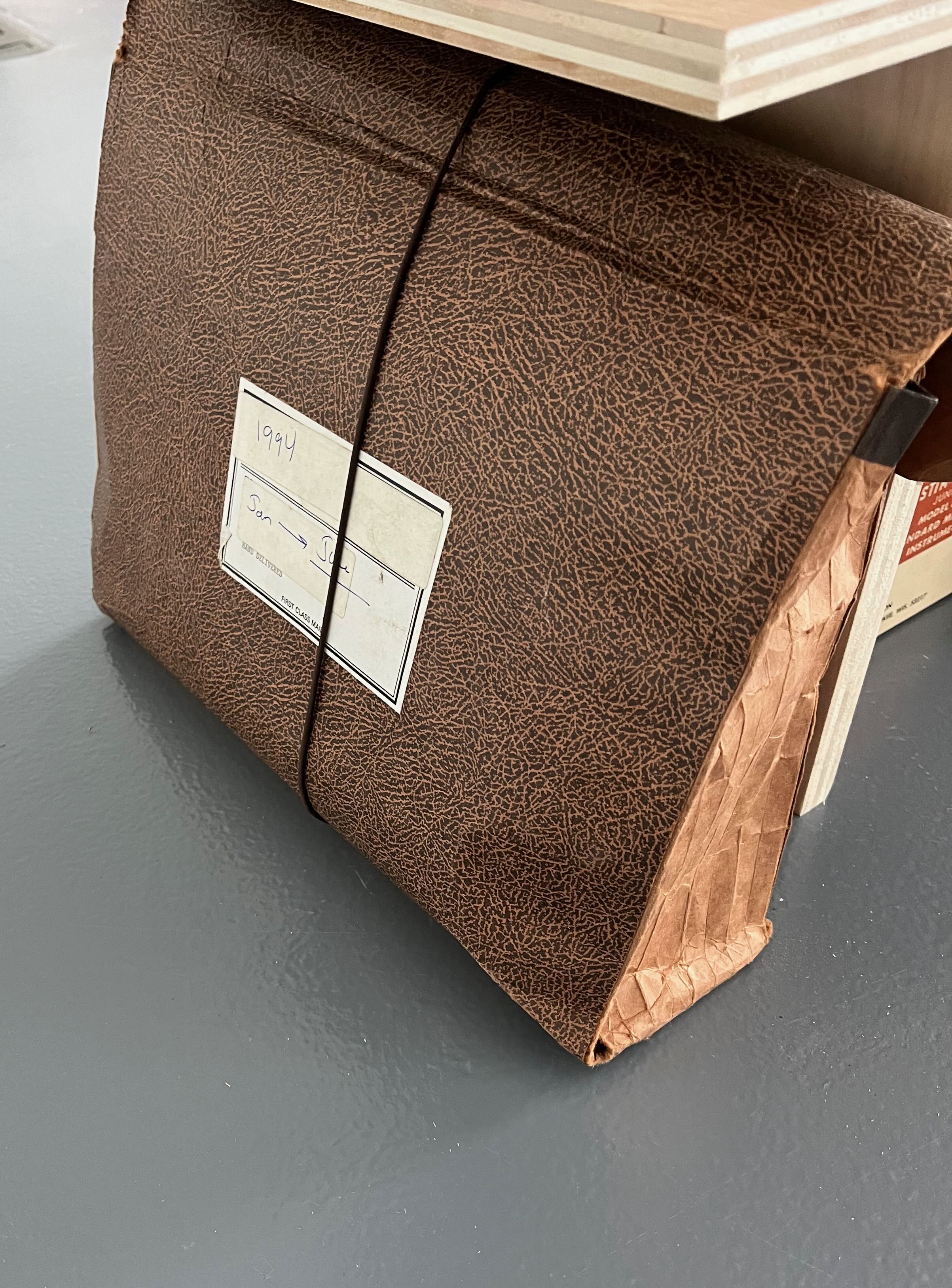 Image of a faux leather accordion folder labeled 1994