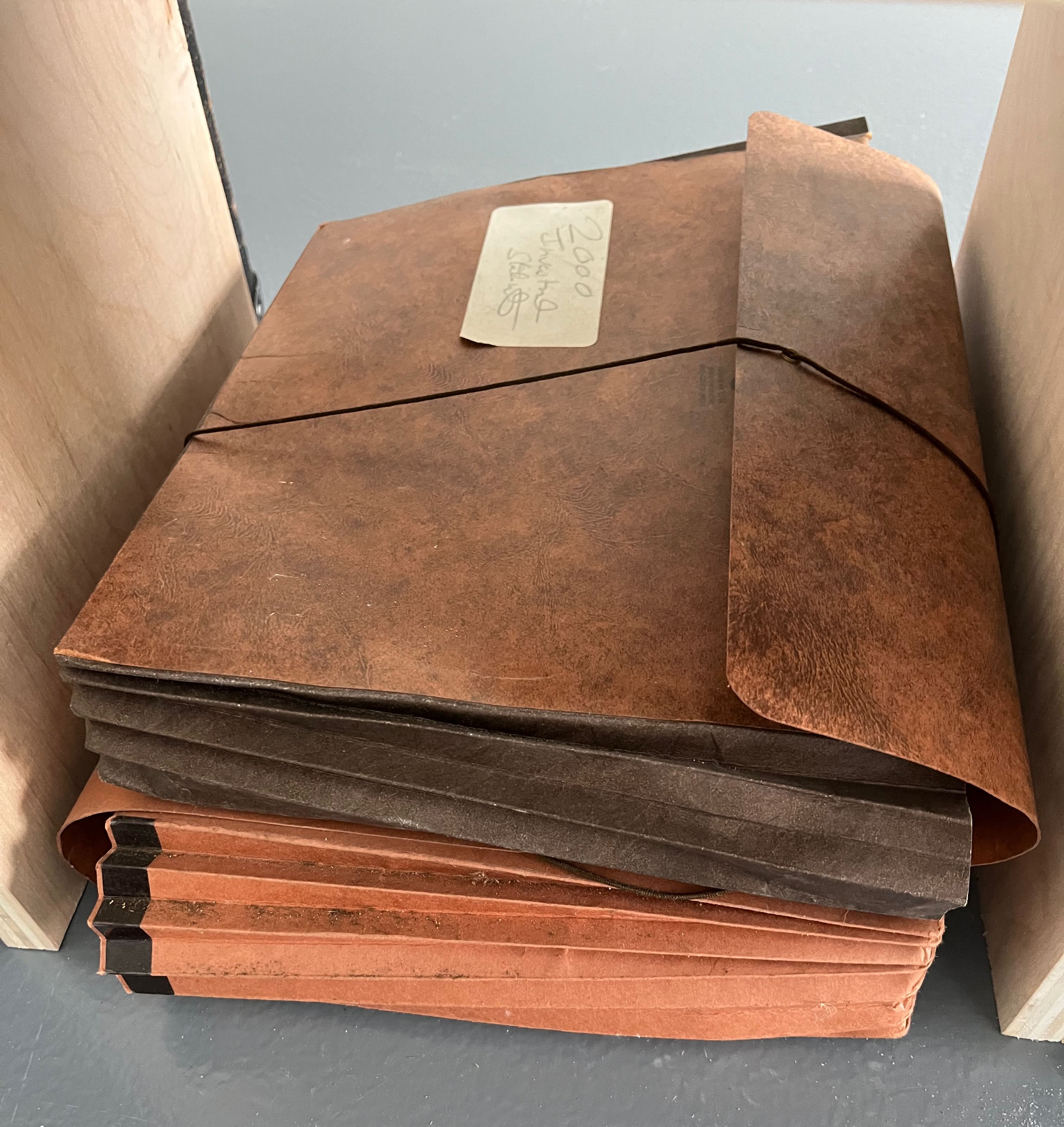 Image of two stacked paper accordion folders, the top one labeled 2000 Investment with some other illegible text