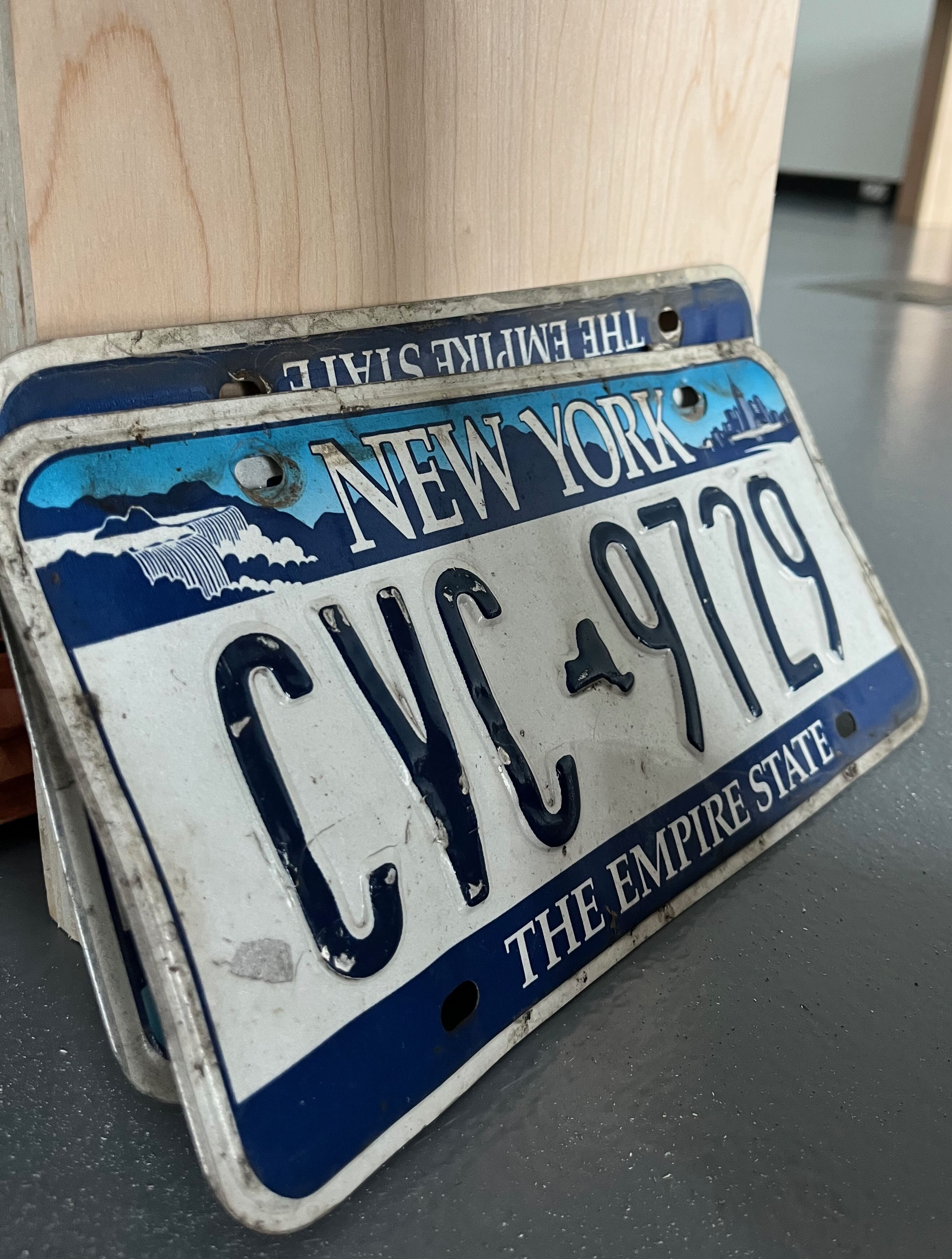 Image of two old New York license plates with number CVC9729
