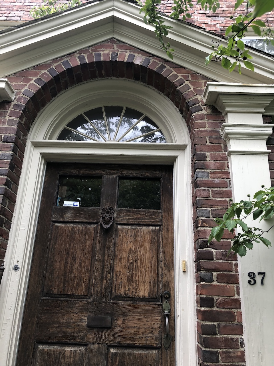 Image of a doorway to a brick house with the number 37