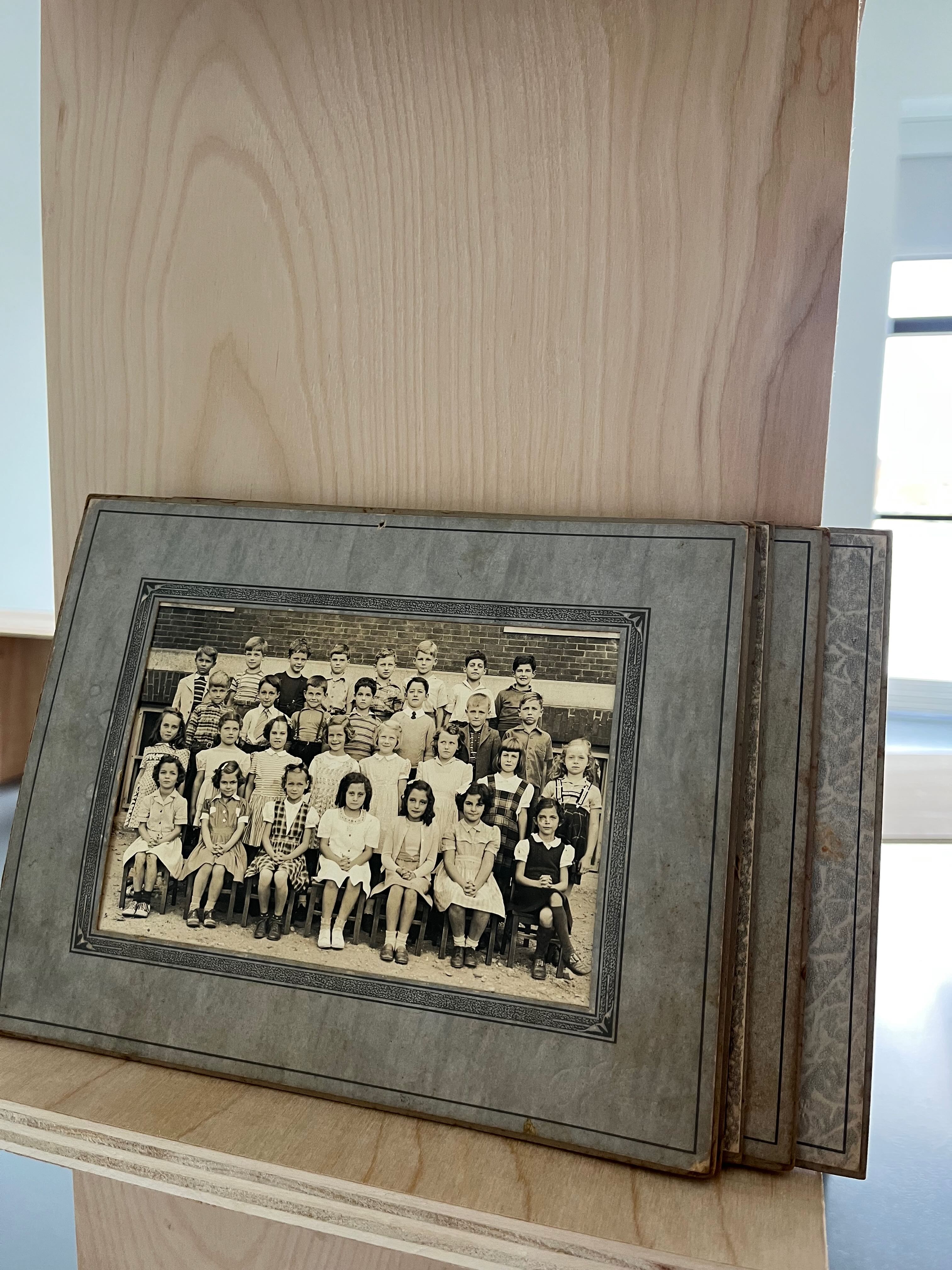 Image of a stack of old elementary school class photos